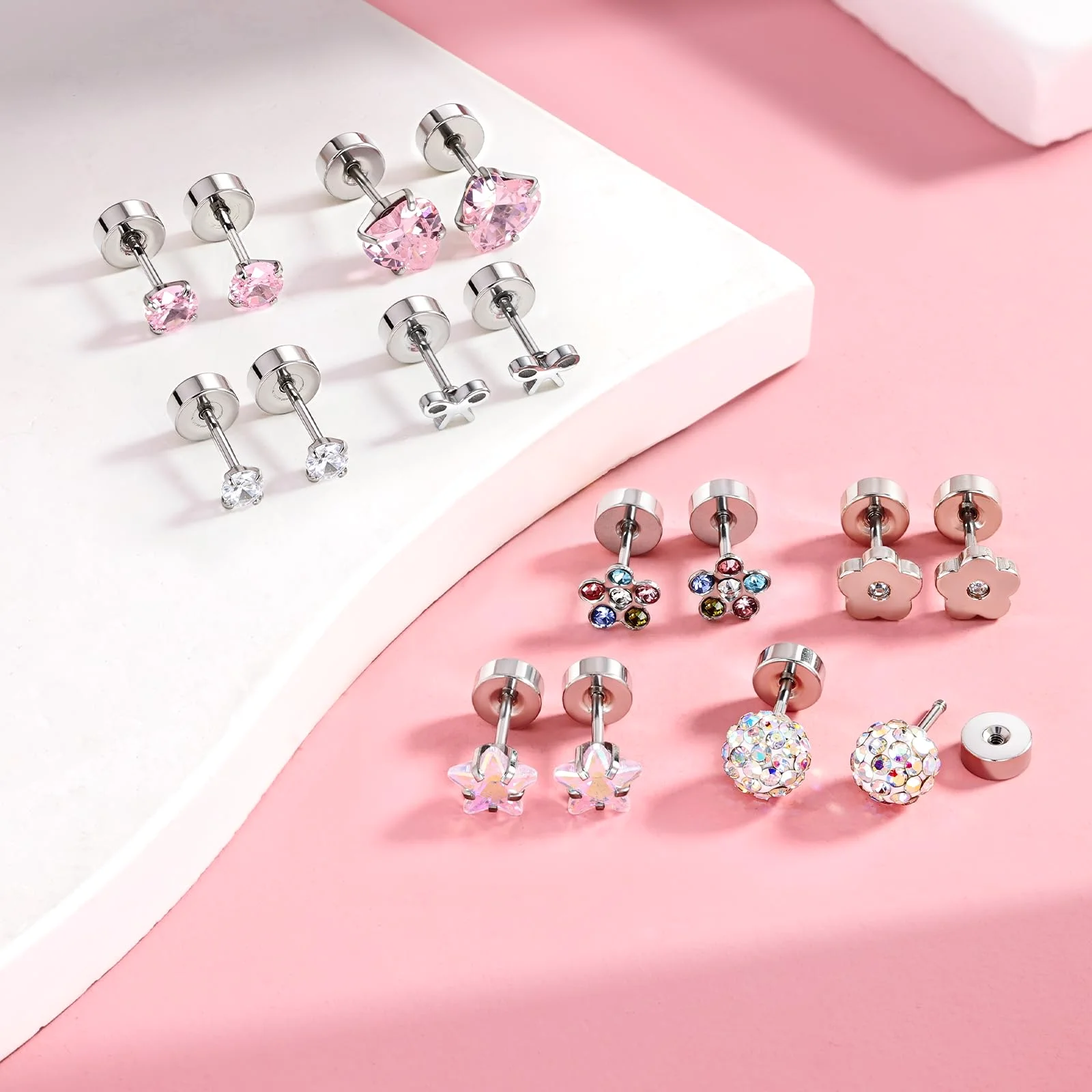 A dozen small screw back pairs for children on pink and white blocks: pink hearts, clear stones, flowers and glittered balls